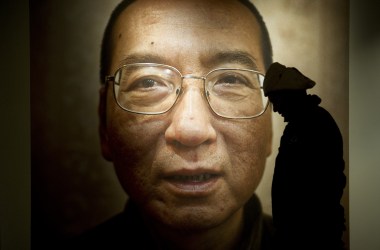 A man walks in front of a poster of Liu Xiaobo at an exhibition at the Nobel Peace Center in Oslo, Norway, on December 9th, 2010.