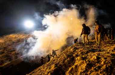 Central American migrants run away from tear gas after they try to cross from Tijuana into California on January 1st, 2019.