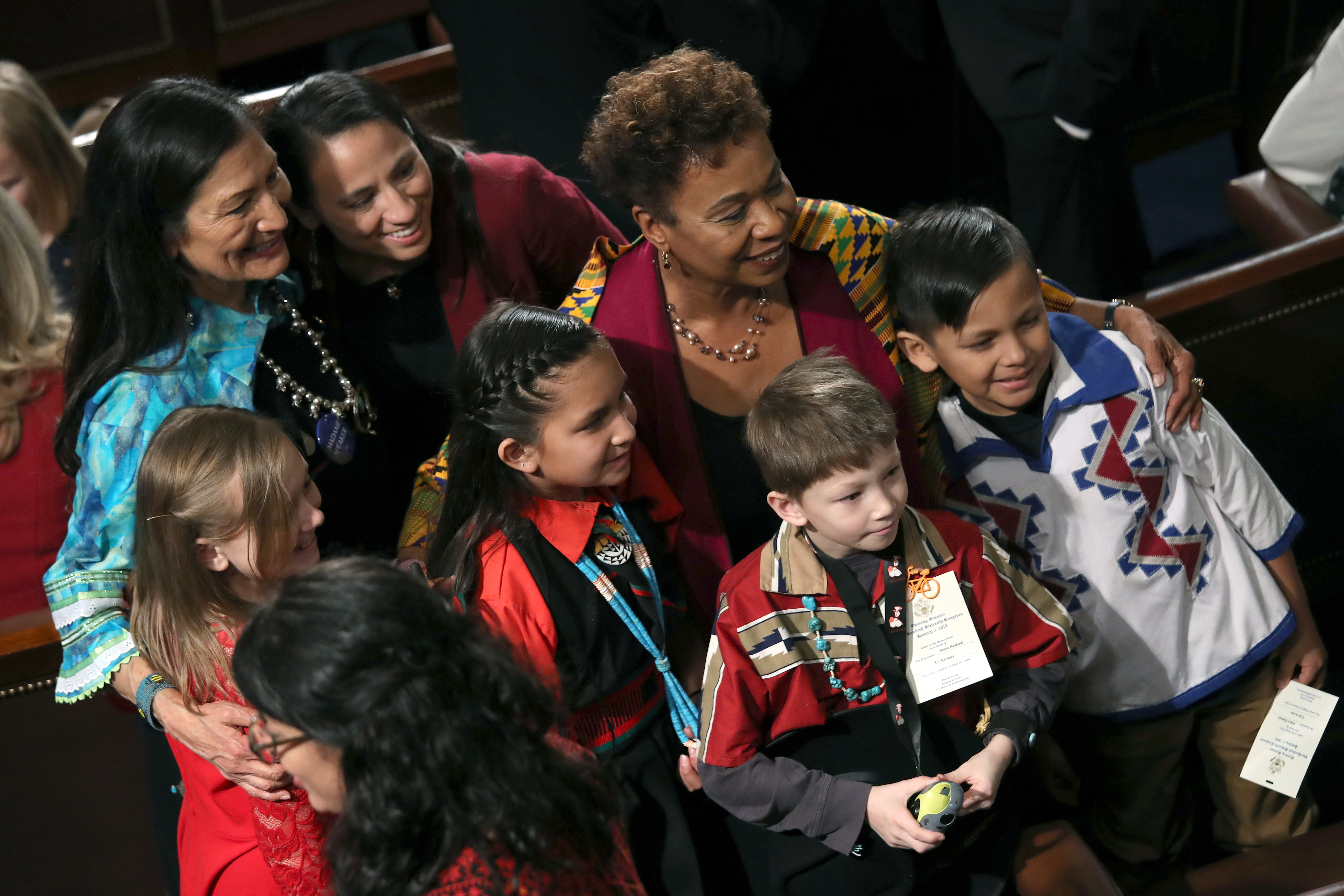 Children pose with Representative Deb Haaland (D-New Mexico), Representative Sharice Davids (D-Kansas), and Representative Barbara Lee (D-California) during the first session of the 116th Congress at the U.S. Capitol on January 3rd, 2019.