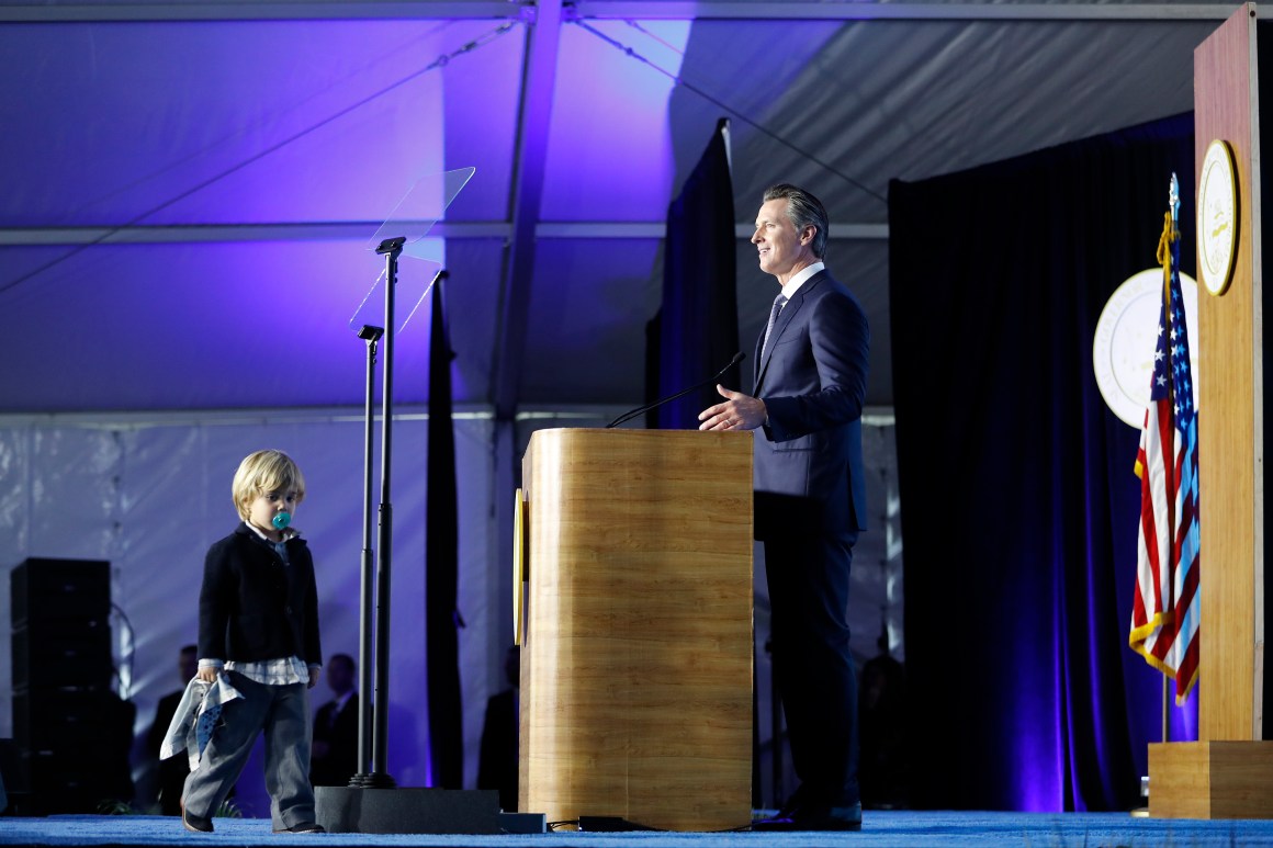 Governor Gavin Newsom delivers his inaugural address as his son Dutch, age two, walks on stage on January 7th, 2019, in Sacramento, California.