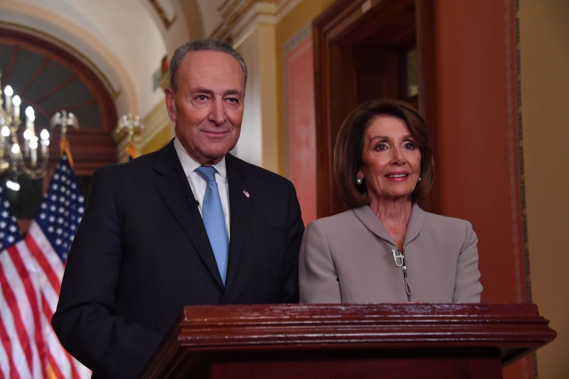 House Speaker Nancy Pelosi and Senate Democratic leader Chuck Schumer pose for pictures after delivering a response to President Donald Trump's televised address to the nation on border funding at the Capitol in Washington, D.C., on January 8th, 2019.