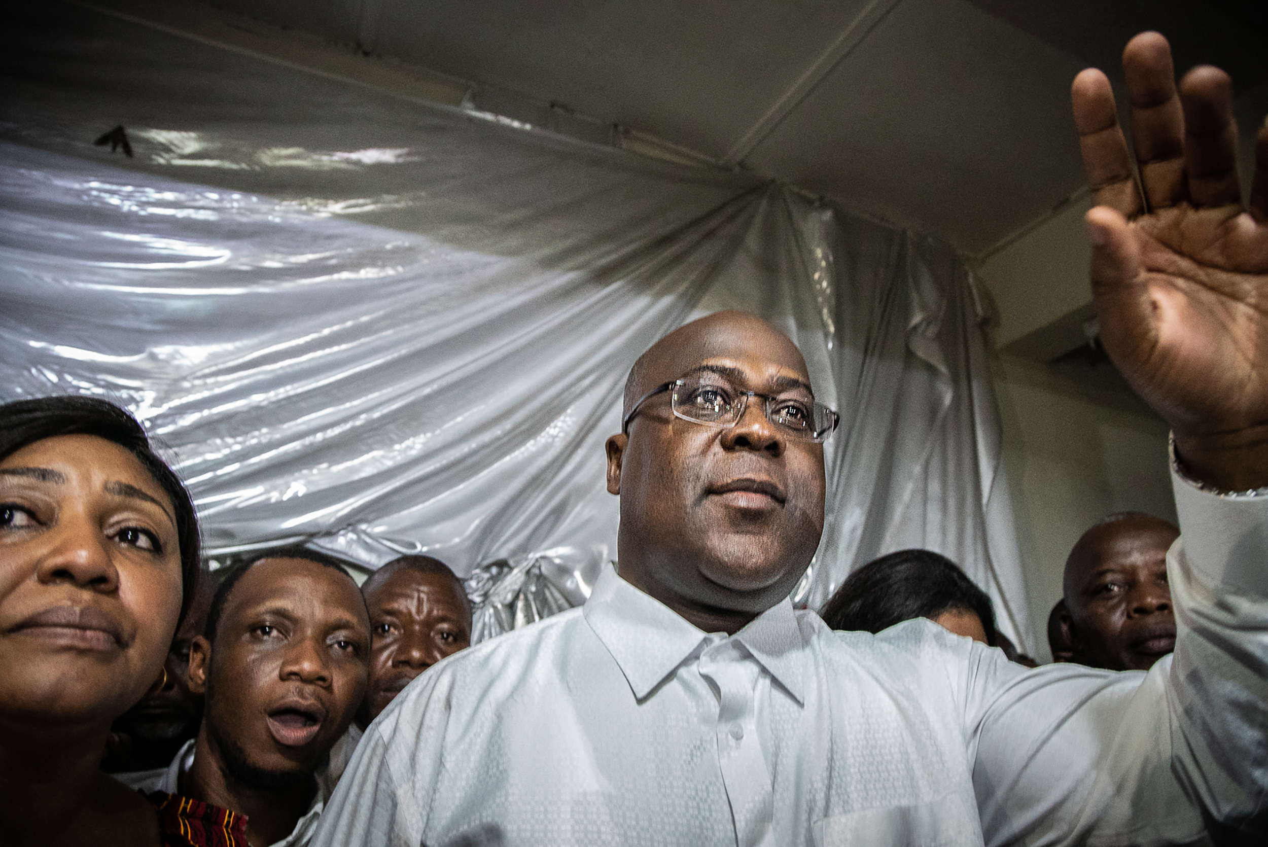 Tshisekedi gestures as he is surrounded by his wife, relatives, and supporters of his party, the Union for Democracy and Social Progress, a few minutes after he was declared winner of the presidential election by the CENI, in his father's historic residence in Limete, Kinshasa, on January 10th, 2019.