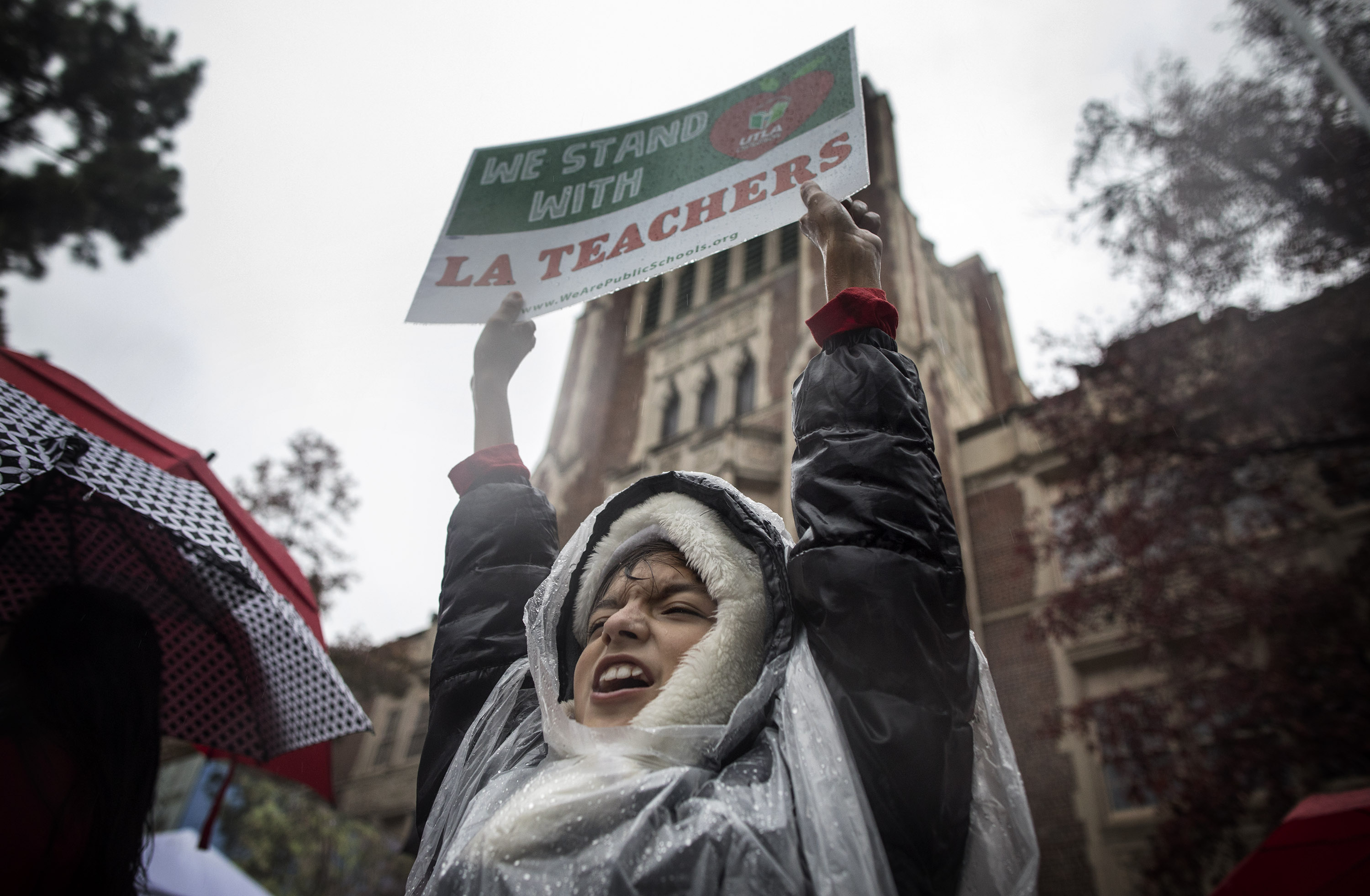 Student Alessandro Niculescu joins teachers, students, friends, and family to protest and picket in the pouring rain outside John Marshall High School during a United Teachers Los Angeles strike on Monday, January 14th, 2019, in Los Angeles, California. Alessandro's father is a teacher at the school. Teachers from the country's second-biggest school district went on strike after weeks of negotiations for more pay and smaller class sizes went nowhere.