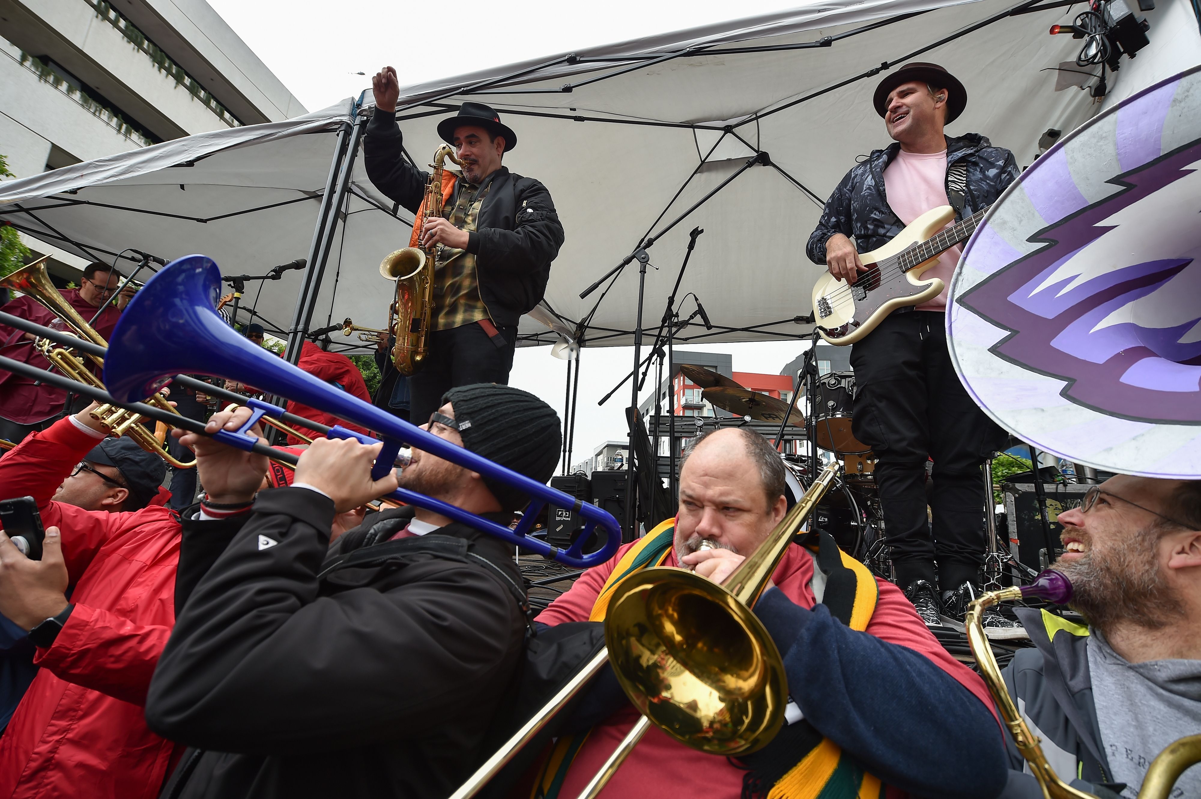 The band Ozomatli (on stage) and public school music teachers (below) perform at a rally by striking teachers in downtown Los Angeles, California, on the second day of the teachers strike on Tuesday, January 15th, 2019.