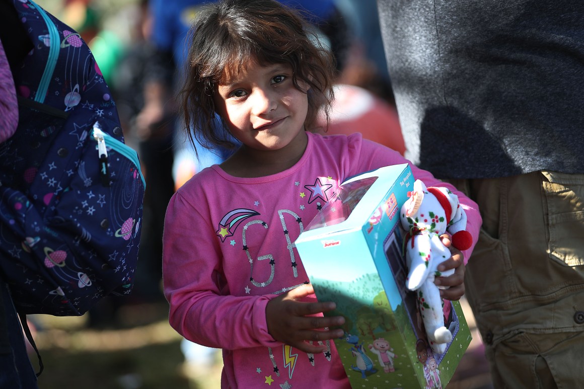 Envy Silva, whose family is originally from Guatemala, holds a holiday toy she received from immigration activists across the street from the Miramar Immigration and Customs Enforcement Facility, where asylum seekers, refugees, and immigrants come from across South Florida for their ICE check-ins, on December 19th, 2018. The activists wanted to show a message of love and unity amid what they say are attacks on immigrants in the United States.