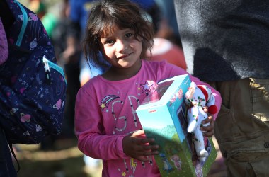 Envy Silva, whose family is originally from Guatemala, holds a holiday toy she received from immigration activists across the street from the Miramar Immigration and Customs Enforcement Facility, where asylum seekers, refugees, and immigrants come from across South Florida for their ICE check-ins, on December 19th, 2018. The activists wanted to show a message of love and unity amid what they say are attacks on immigrants in the United States.