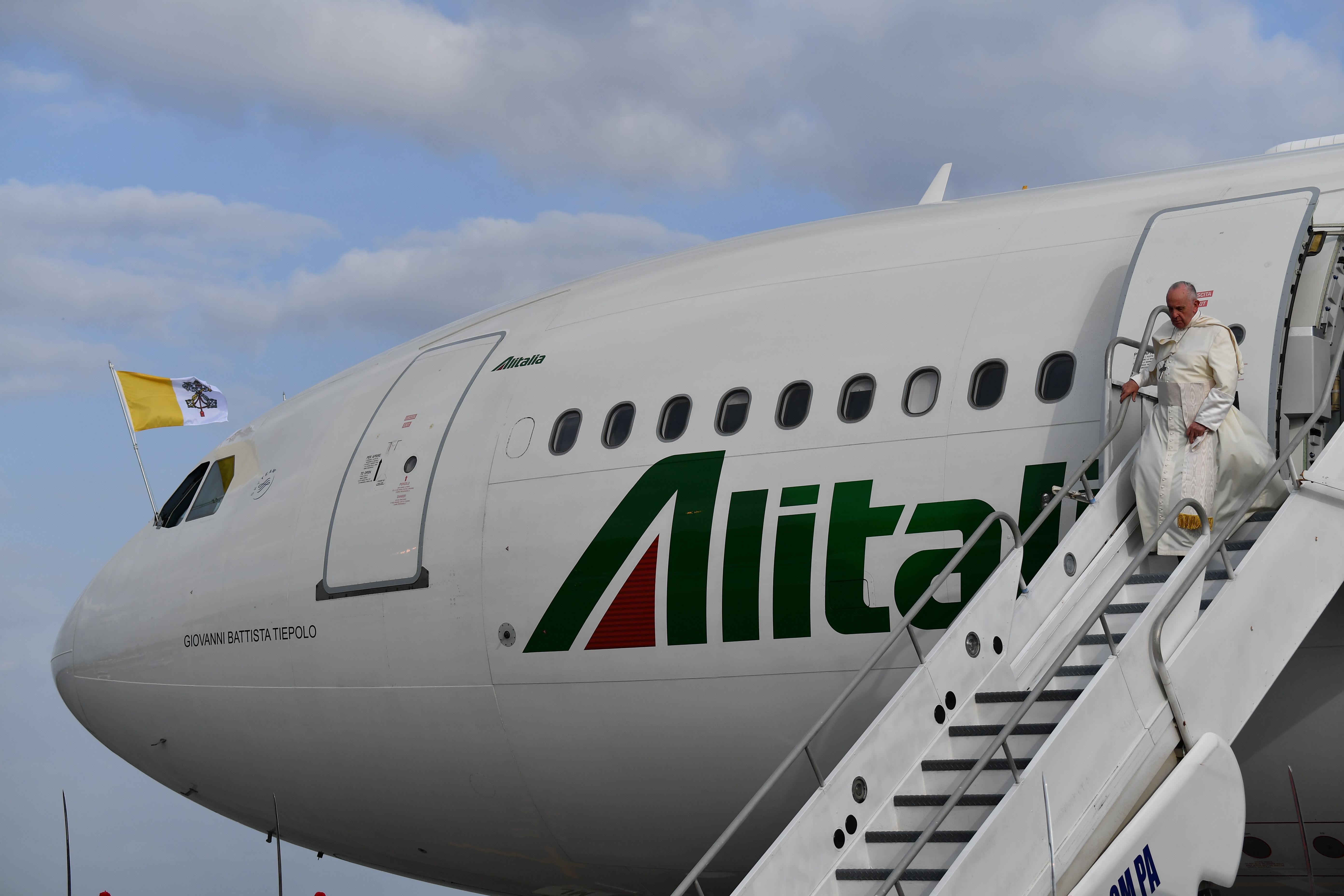 Pope Francis walks down the steps of the plane upon landing at Tocumen International Airport in Panama City on January 23rd, 2019.