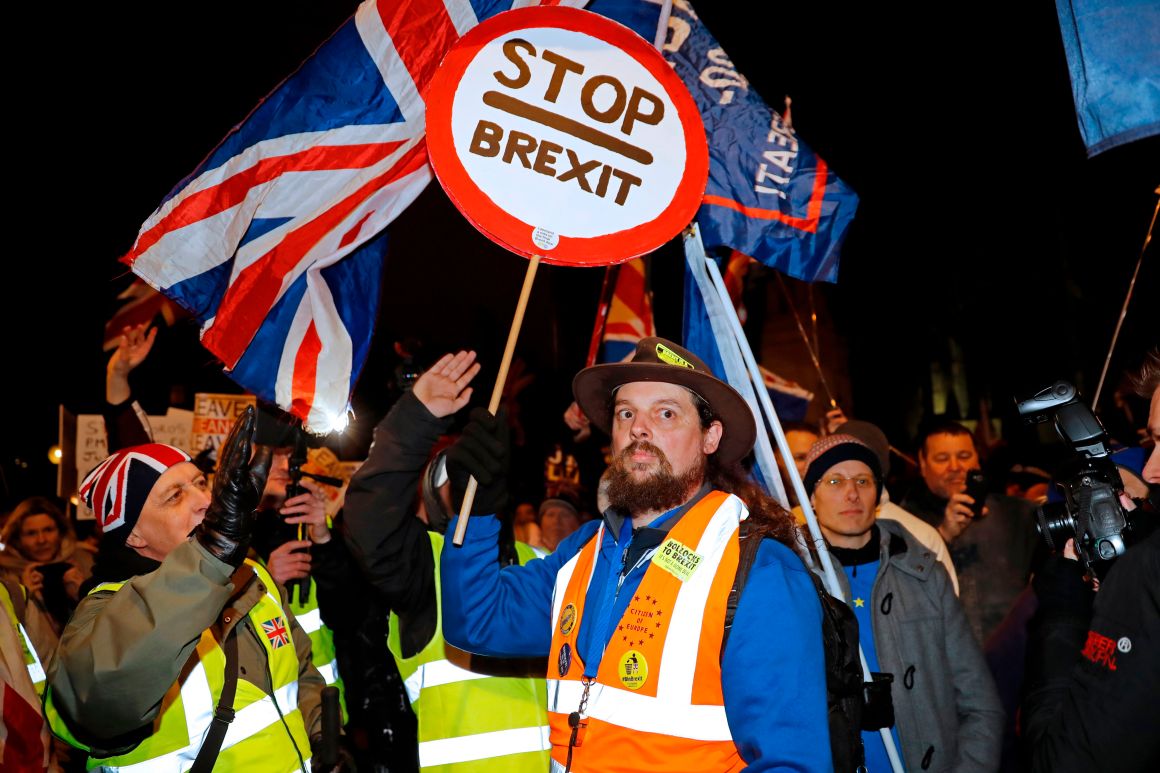 A pro-Brexit activist (left) addresses an anti-Brexit activist (center) as both sides demonstrate outside of the Houses of Parliament in London on January 29th, 2019.