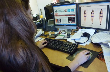 A woman is seen on February 18th, 2011, in Montreal, Quebec, watching an advertisement from the Canadian fashion brand Jacob, which doesn't Photoshop the top model shape in order to promote the body.