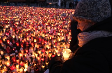 A mourner holds a candle for murdered Gdansk Mayor Pawel Adamowicz on January 17th, 2019, in Gdansk, Poland. Adamowicz was stabbed on stage while attending a charity event in Gdansk last Sunday and died a day later of his injuries. The suspect is a 27-year-old man with a criminal record who was taken into custody. The coffin carrying Adamowicz's body was displayed in the European Solidarity Centre late Thursday, where the public could pay last respects. Adamowicz's funeral is scheduled for Saturday, January 19th, 2019.