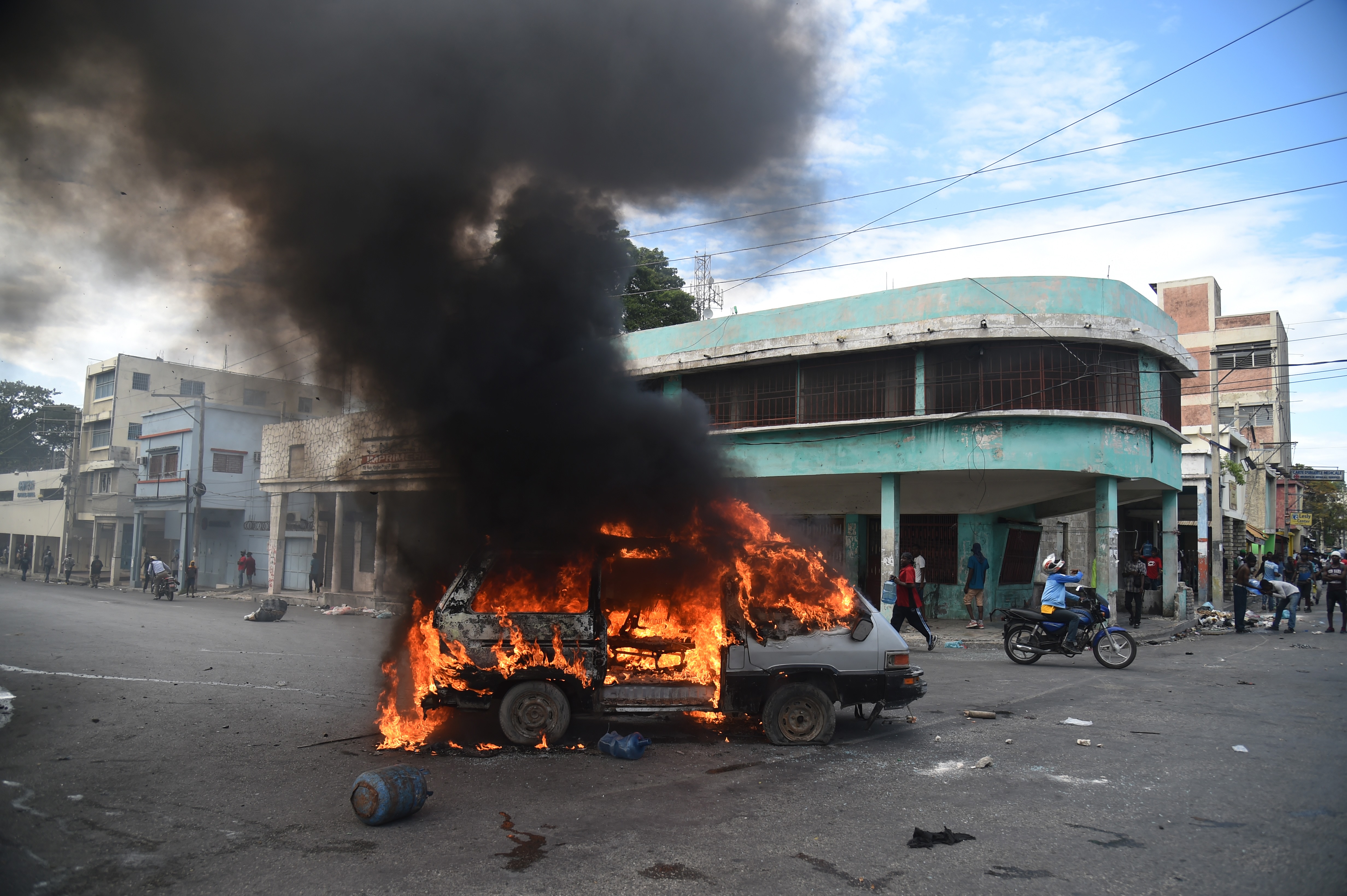 A burning car is seen during clashes in the center of Haitian capital Port-au-Prince on February 12th, 2019, during the sixth day of protests against Haitian President Jovenel Moise and misuse of the PetroCaribe fund.