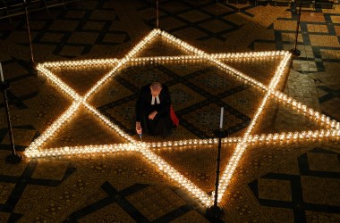 The Reverend Canon Dr. Chris Collingwood, York Minster's Canon Chancellor, lights some of the 600 candles in the form of the Star of David set out on the floor during an event to commemorate Holocaust Memorial Day in the Chapter House at York Minster on January 24th, 2019, in York, England. The ceremony in the minster is one of many international events for Holocaust Memorial Day, held on January 27th. This date marks the liberation of the Auschwitz-Birkenau concentration camp in 1945. The international theme for Holocaust Memorial Day 2019 is "Torn From Home," which encourages people to reflect on how the enforced loss of a safe place to call home is part of the trauma faced by anyone experiencing persecution and genocide. This year also marks the 25th anniversary of the Rwandan genocide, which began in April of 1994, and the 40th anniversary of the end of the Cambodian genocide, which ended in 1979.