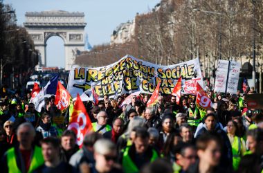 Gilets jaunes (yellow vest) protesters march down the Champs-Elysees in Paris, France, on February 17th, 2019. The yellow vests movement began in November after French President Emmanuel Macron announced impending fuel taxes, which many rural French citizens said they could not afford, and calls for government tax reforms to address the high cost of living and for Macron's resignation.