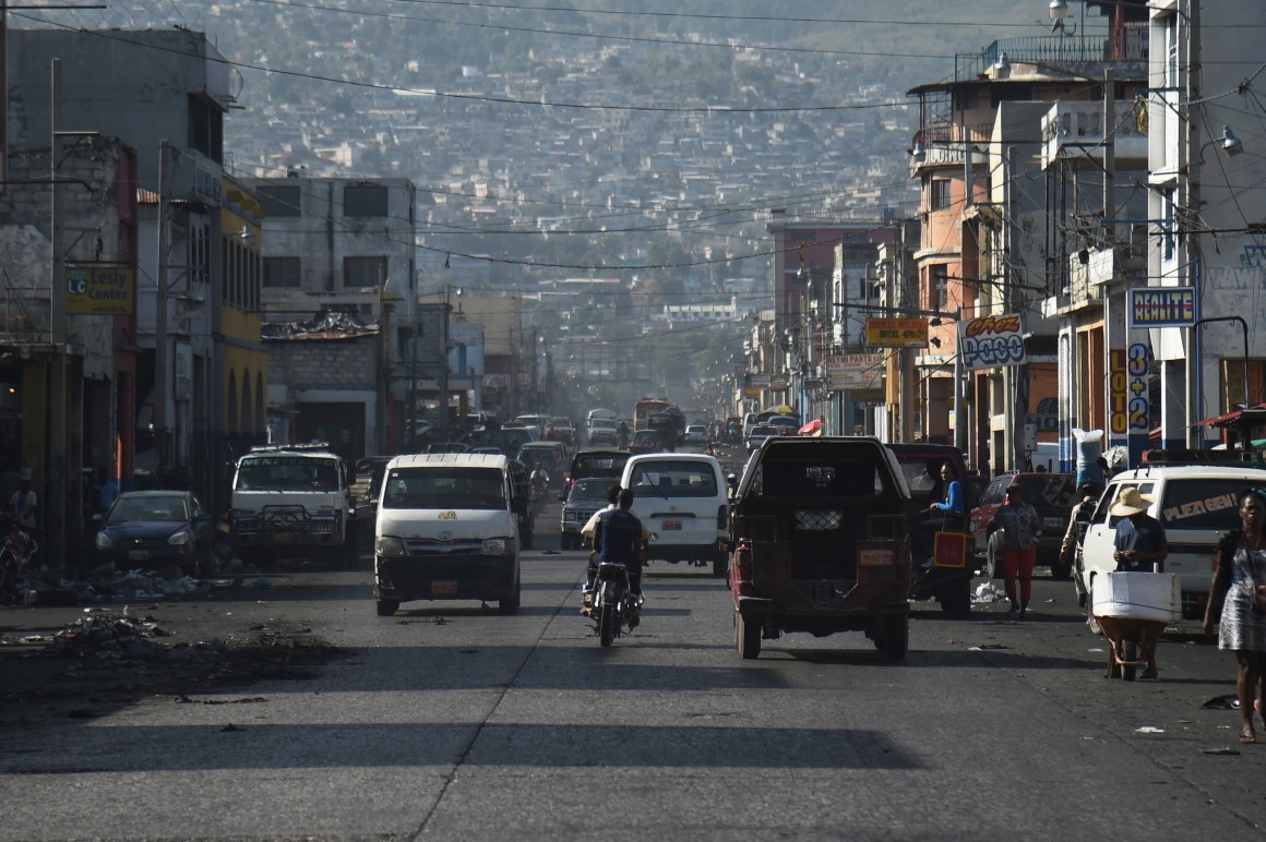 Cars move along a street in the center of the Haitian capital of Port-au-Prince.