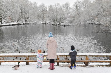 Matilda, two (left), and Oliver, three, feed the ducks with their mother in Stalybridge Country Park on January 30th, 2019, in Lancashire, United Kingdom.