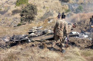 Pakistani soldiers stand next to what Pakistan says is the wreckage of an Indian fighter jet shot down in Pakistan-controlled Kashmiron on February 27th, 2019.