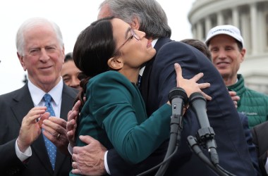 Representative Alexandria Ocasio-Cortez and Senator Ed Markey hug each other as other Congressional Democrats look on during a news conference unveiling a Green New Deal resolution in front of the U.S. Capitol on February 7th, 2019, in Washington, D.C.