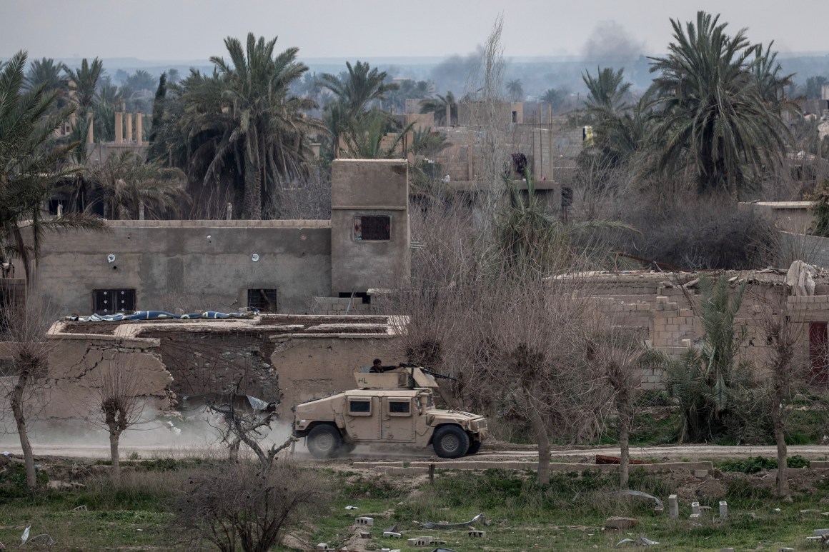 A Syrian Democratic Forces armored vehicle drives through streets near the frontline on February 10th, 2019, in Bagouz, Syria, as part of the SDF's campaign to oust ISIS fighters from the last village in eastern Syria held by the extremist group.