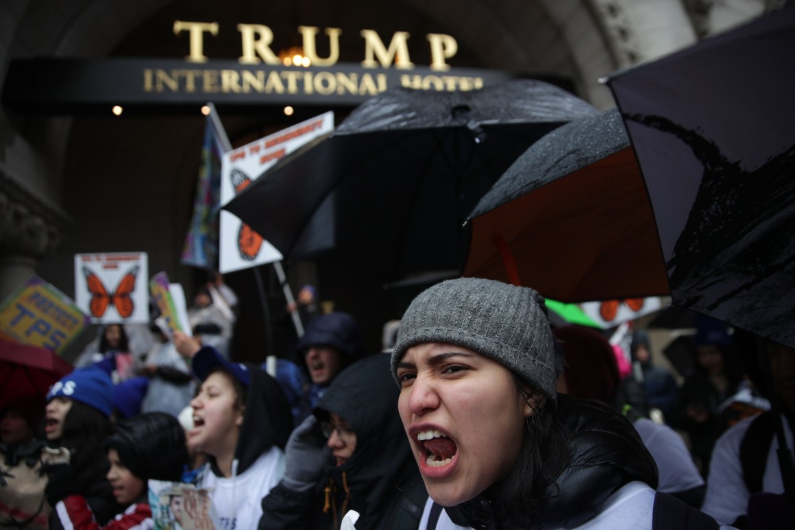 Immigration activists shout slogans as they protest outside Trump International Hotel during a march on February 12th, 2019, in Washington, D.C. Activists called on Congress to grant permanent protections to immigrants with Temporary Protected Status.