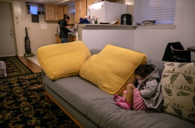 Sandra Sanchez, a Honduran woman and asylum seeker, preparing lunch for her daughter.