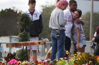 Students from Marjory Stoneman Douglas High School spend time together at a memorial set up outside the school on February 14th, 2019, in Parkland, Florida. A year ago on February 14th, 14 students and three staff members were killed during a mass shooting. For the one-year anniversary of the shooting, Pacific Standard took a look at federal, local, and non-governmental gun-violence proposals.