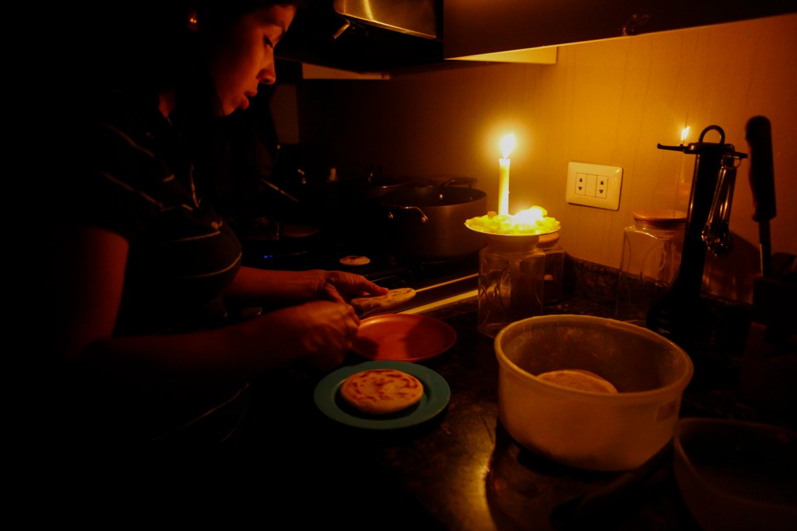 On March 12th, 2019, a woman cooks dinner at her house during a blackout, which affects the water pumps, in Caracas, Venezuela. Over 70 percent of the country was in darkness amid an ongoing political dispute between President Nicolas Maduro and Juan Guaido, who has been declared interim president by the national assembly.