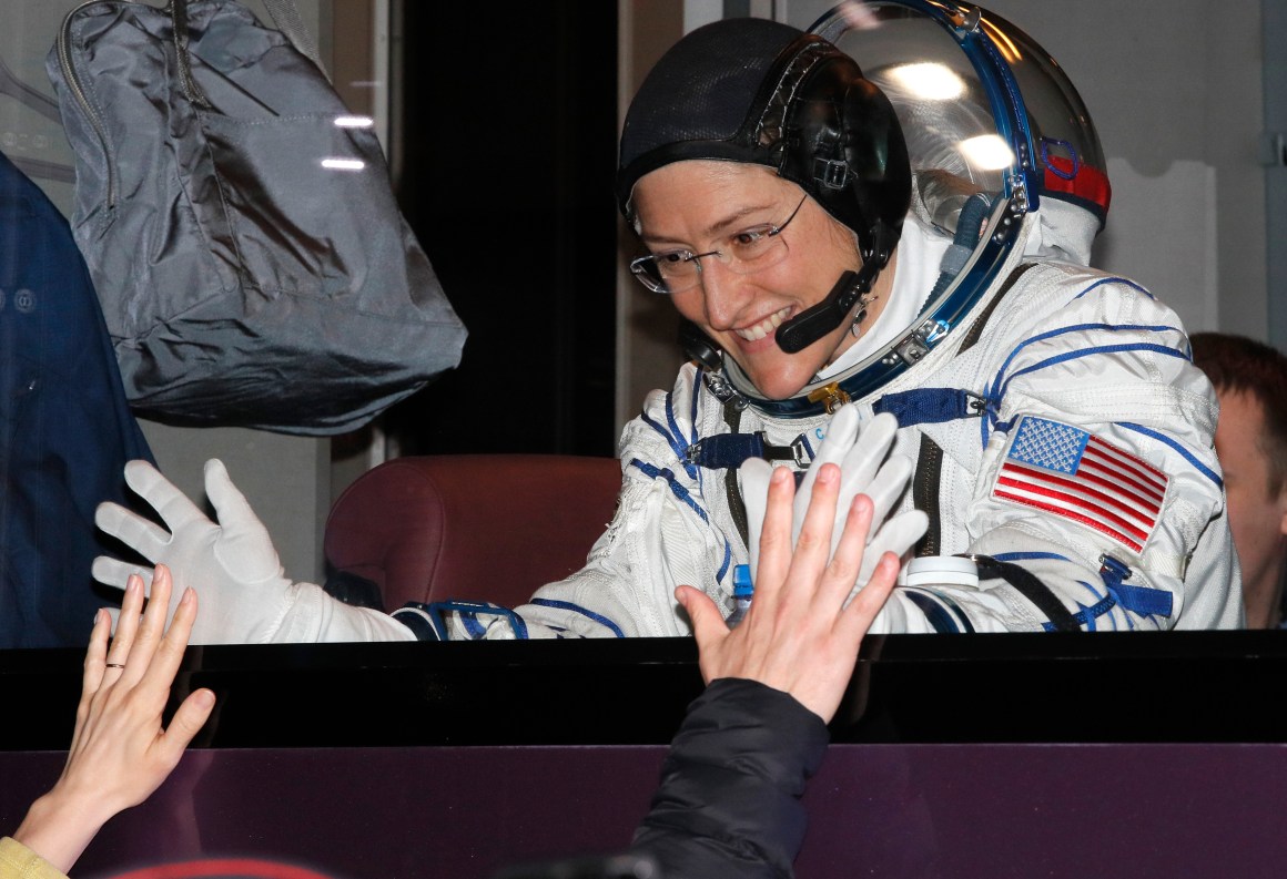 NASA astronaut Christina Koch gestures from inside a bus shortly before her expedition launched at the Russian-leased Baikonur cosmodrome in Kazakhstan on March 14th, 2019.