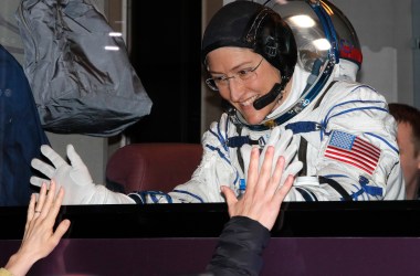 NASA astronaut Christina Koch gestures from inside a bus shortly before her expedition launched at the Russian-leased Baikonur cosmodrome in Kazakhstan on March 14th, 2019.