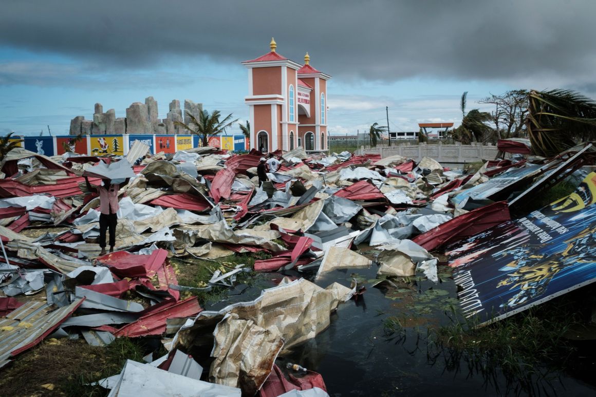 People collect metal sheets from a damaged supermarket to re-build their destroyed houses following the devastation caused by Cyclone Idai in Beira, Mozambique, on March 21st, 2019.