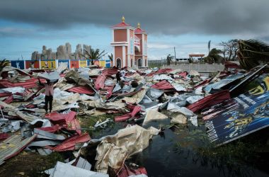 People collect metal sheets from a damaged supermarket to re-build their destroyed houses following the devastation caused by Cyclone Idai in Beira, Mozambique, on March 21st, 2019.