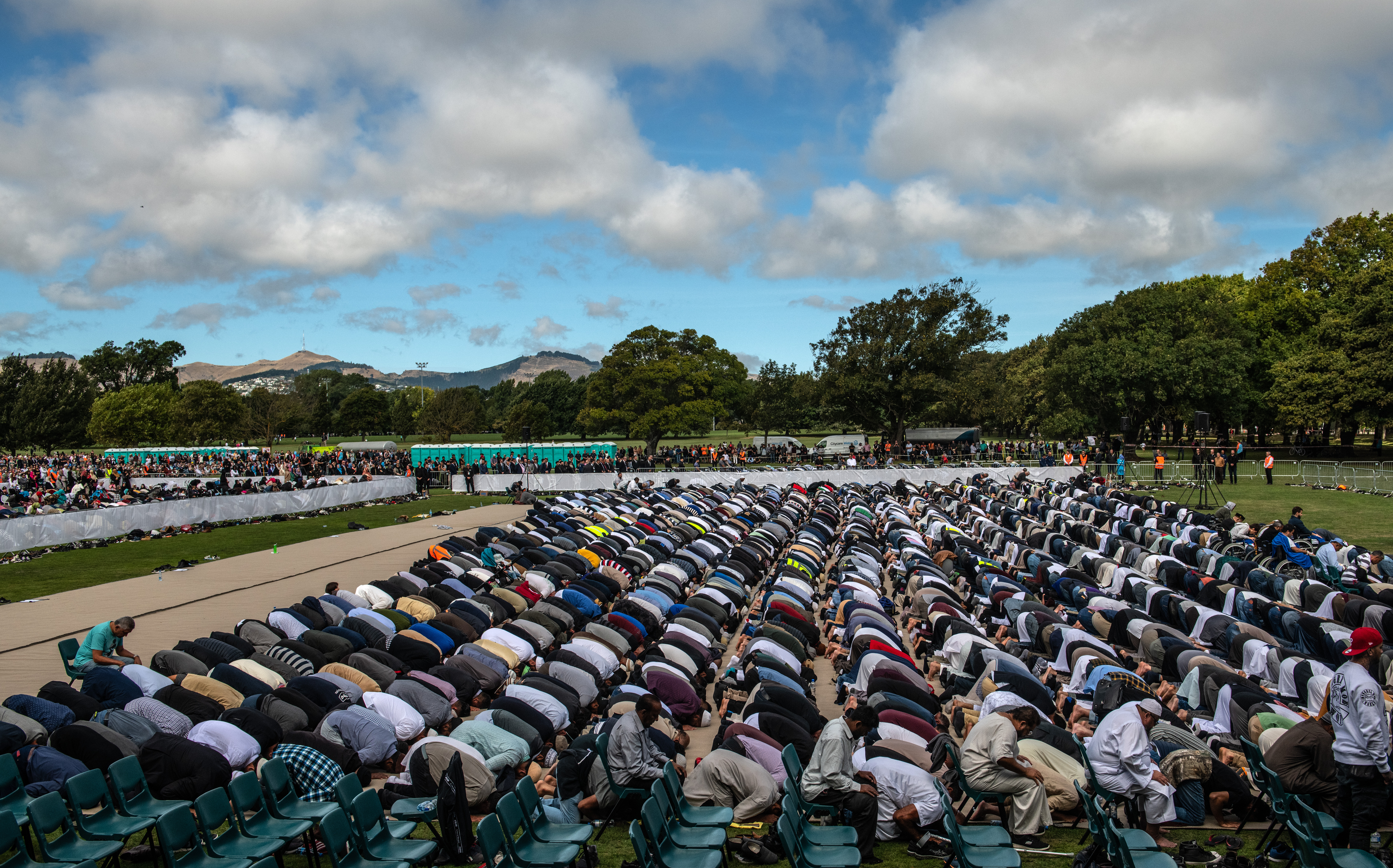 Muslims attend Friday prayers in a park near Al Noor mosque on March 22nd, 2019, in Christchurch, New Zealand. Fifty people were killed, and dozens were injured in Christchurch on Friday, March 15th, when a gunman opened fire at the Al Noor and Linwood mosques.