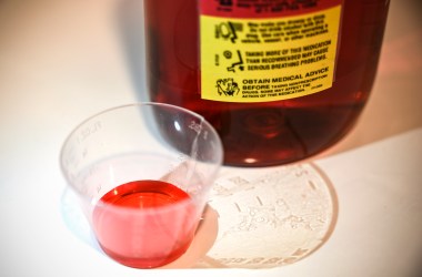 A bottle of liquid oxycodone, an opioid pain relief medication, and a dose of the solution sit on a table in Washington, D.C., on March 29th, 2019.