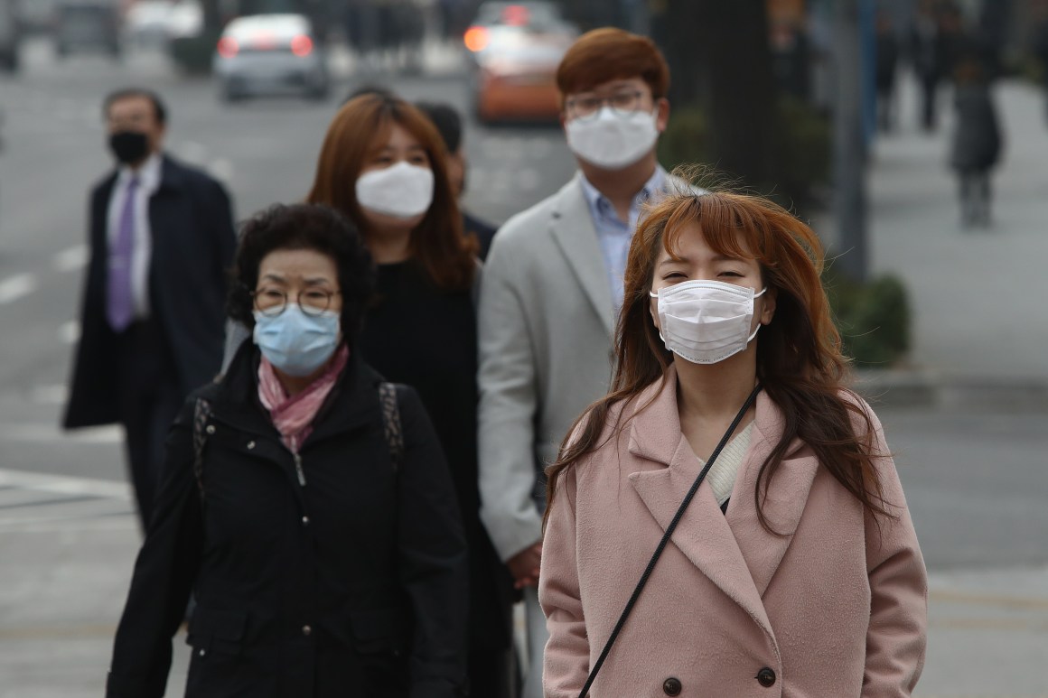 Pedestrians wearing masks walk during a polluted day in Seoul, South Korea.