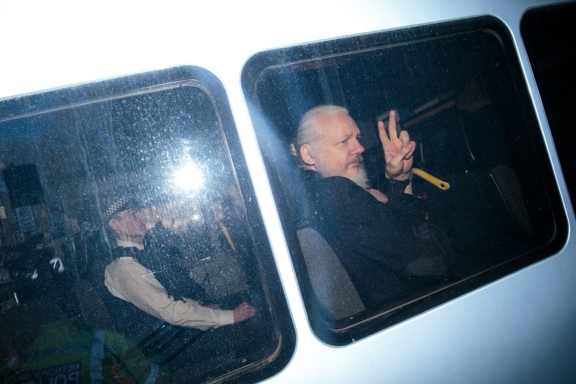 Julian Assange waves to the media from a police vehicle on his arrival at Westminster Magistrates' Court on April 11th, 2019, in London, England.