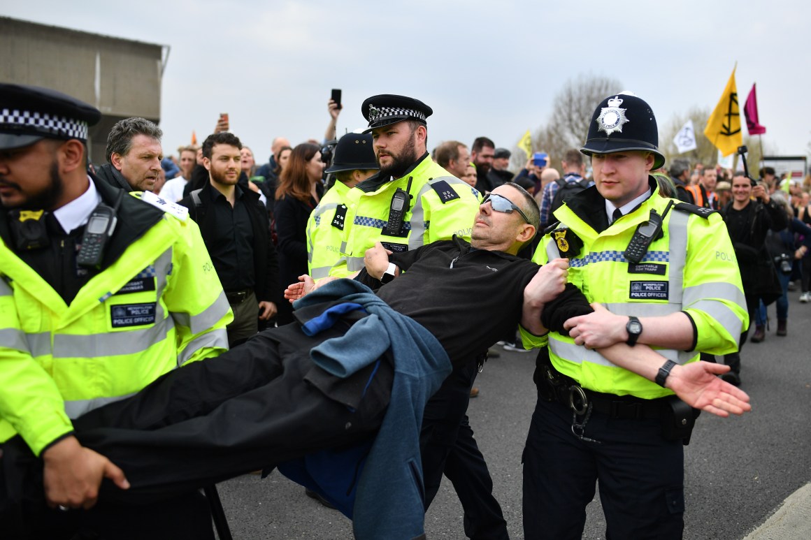 Police officers remove protesters from a blockade on Waterloo Bridge during the second day of a coordinated protest by the Extinction Rebellion group on April 16th, 2019, in London, England. More than 100 arrests have been made, with demonstrations blocking a number of locations across the capital.