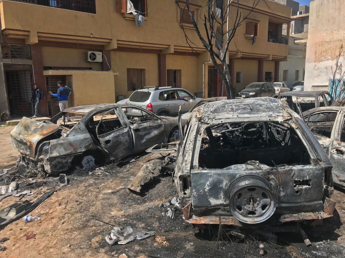 Two men stand at the scene of an overnight rocket attack, which no group has claimed responsibility for so far, in the Libyan capital of Tripoli on April 17th, 2019. A number of rockets struck parts of Tripoli late yesterday after strongman Khalifa Haftar launched an offensive earlier this month to take the Libyan capital, witnesses and journalists said. At least seven powerful explosions rocked the city center. Shortly afterwards, witnesses said, columns of smoke were seen above the district of Abu Salim in the south of the city, which was hit by a number of rockets.