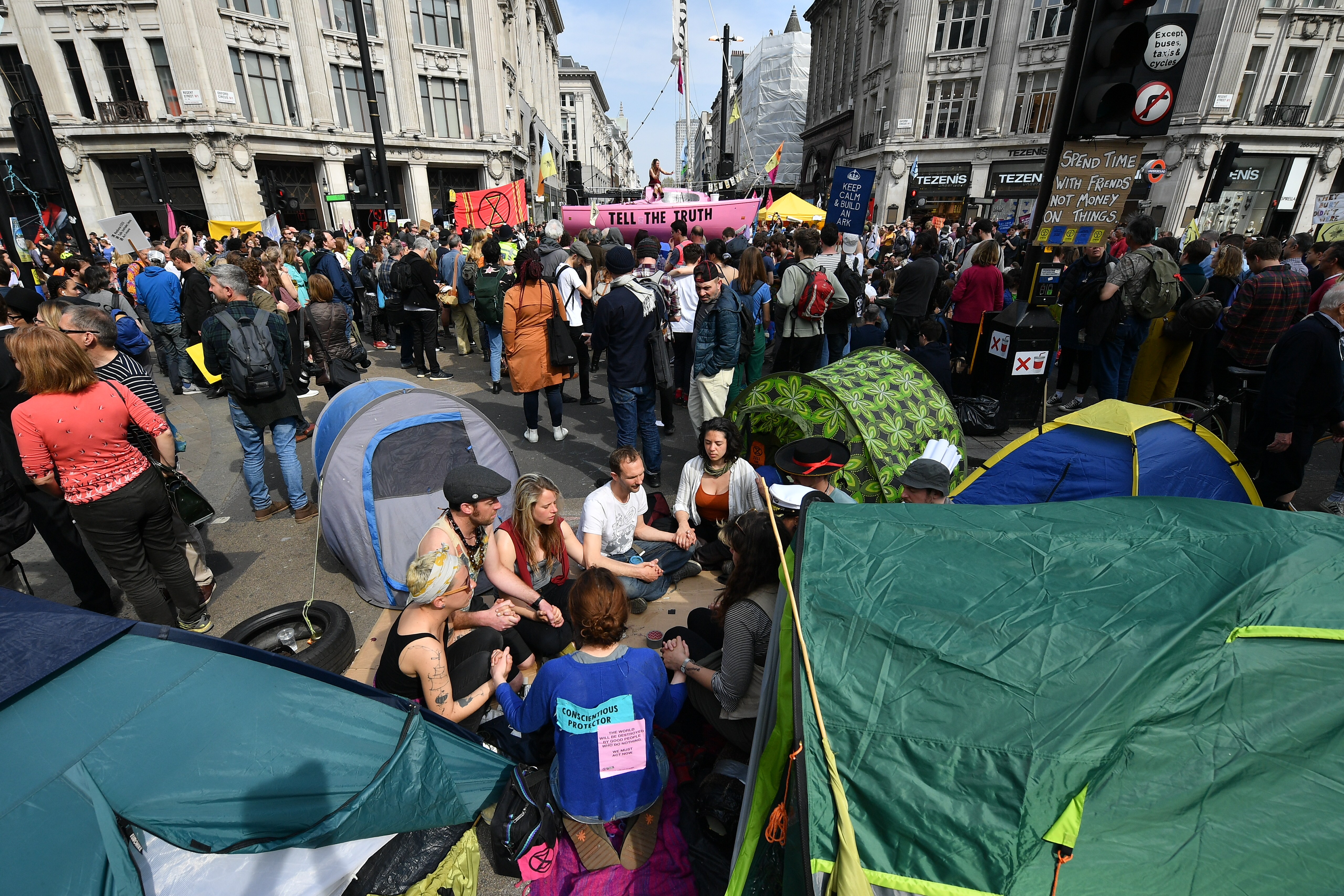 Climate protesters gather around a boat at Oxford Circus during a coordinated protest by the Extinction Rebellion group on April 18th, 2019, in London, England.