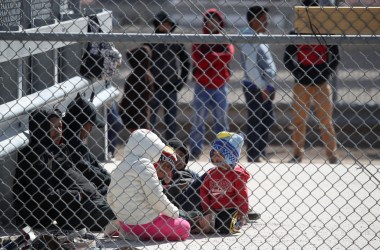 Detained migrants wait to be transported by U.S. Border Patrol at the border of the United States and Mexico on March 31st, 2019, in El Paso, Texas.