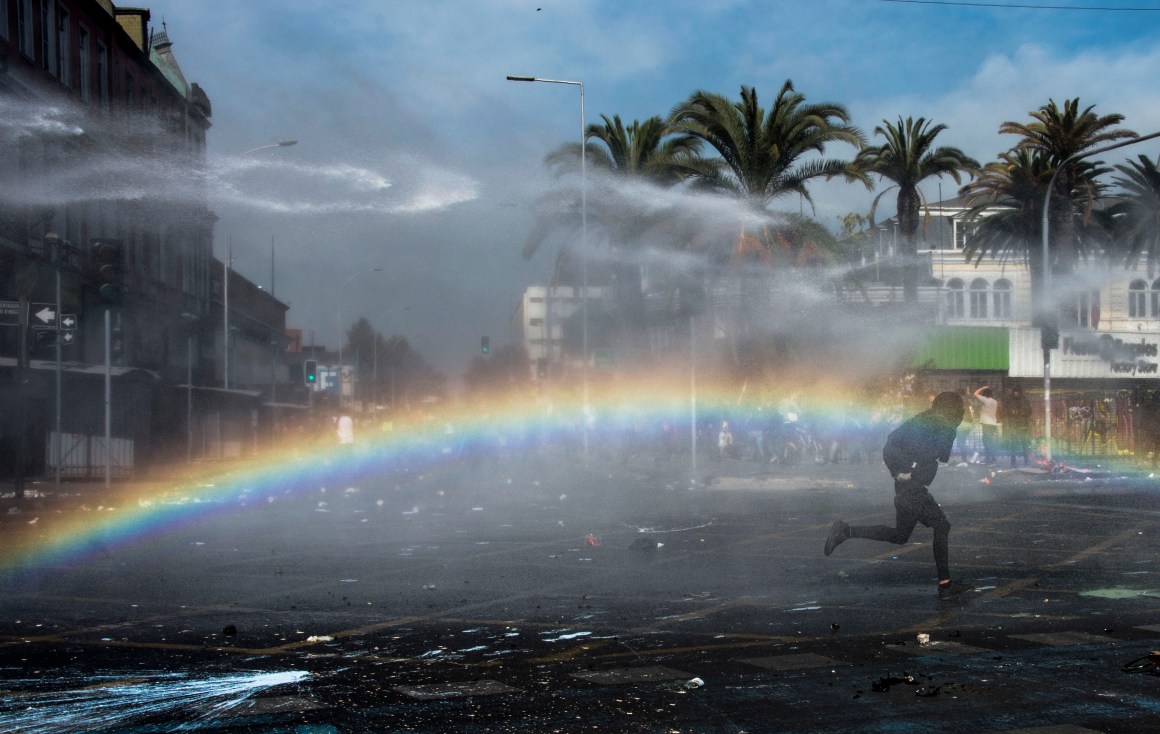 A Chilean demonstrator clashes with riot police during a May Day rally in Santiago, Chile, on May 1st, 2019.