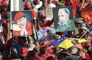 Portraits depicting late Venezuelan President Hugo Chávez and the late Cuban leader Fidel Castro on display during a May Day rally in Caracas, Venezuela, on May 1st, 2019.