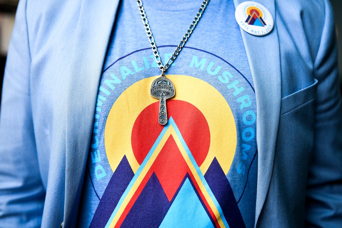 Campaign manager for the Denver Psilocybin Initiative Kevin Matthews wears a mushroom necklace at an election watch party for a bill to decriminalize psilocybin mushrooms.