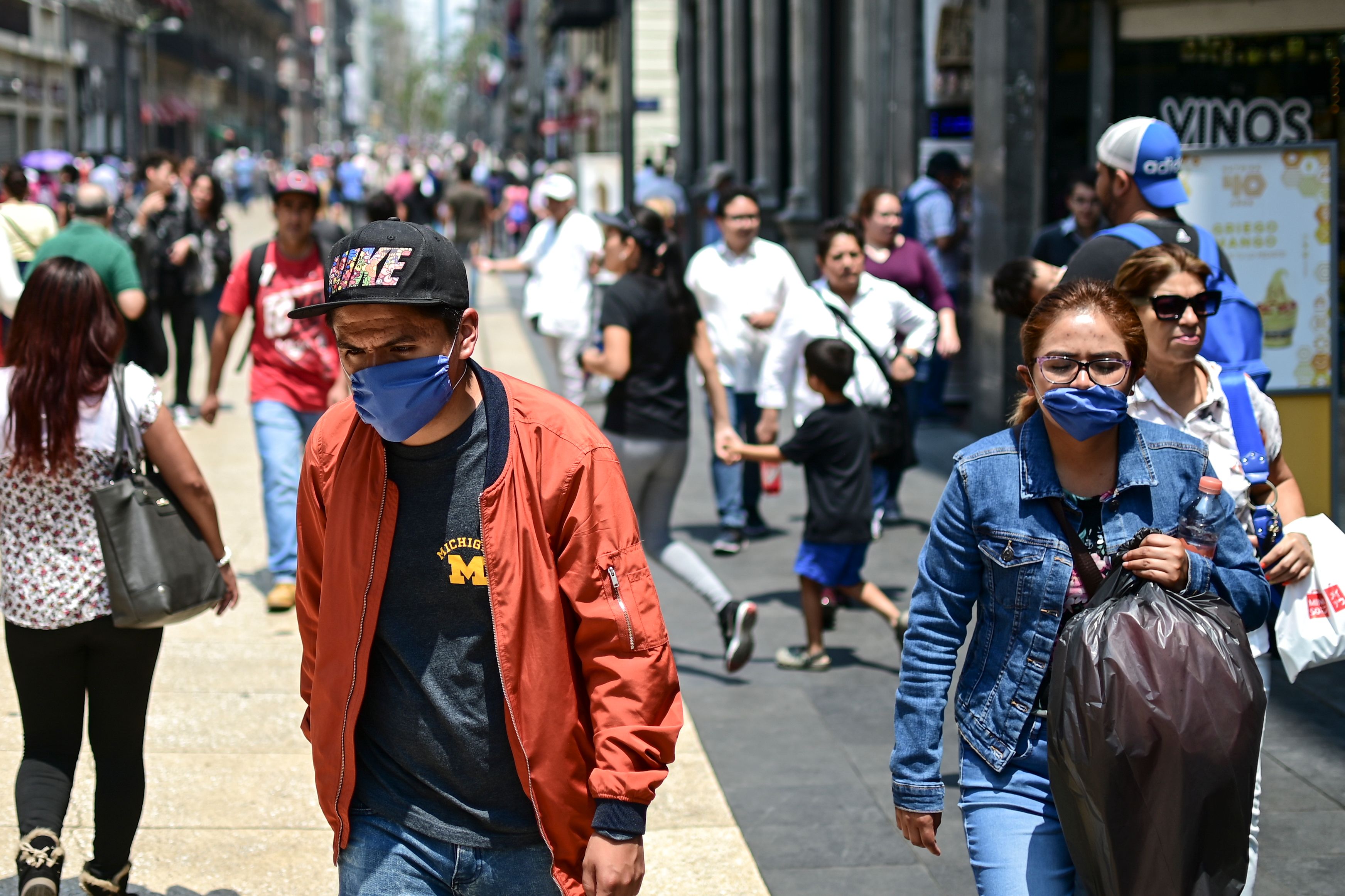 People wear face masks due to air pollution, in downtown Mexico City, on May 14th, 2019.