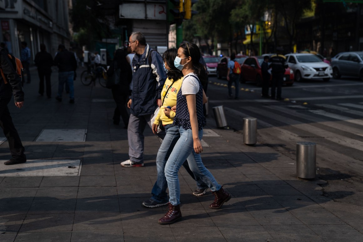 Two women wear face masks on May 16th, 2019, in Mexico City, Mexico. Mexico City's air pollution has worsened as a consequence of high temperatures, lack of rain, and fires located around the city's valley, where people have been advised to stay indoors and avoid using their vehicles, and schools have been ordered to close.