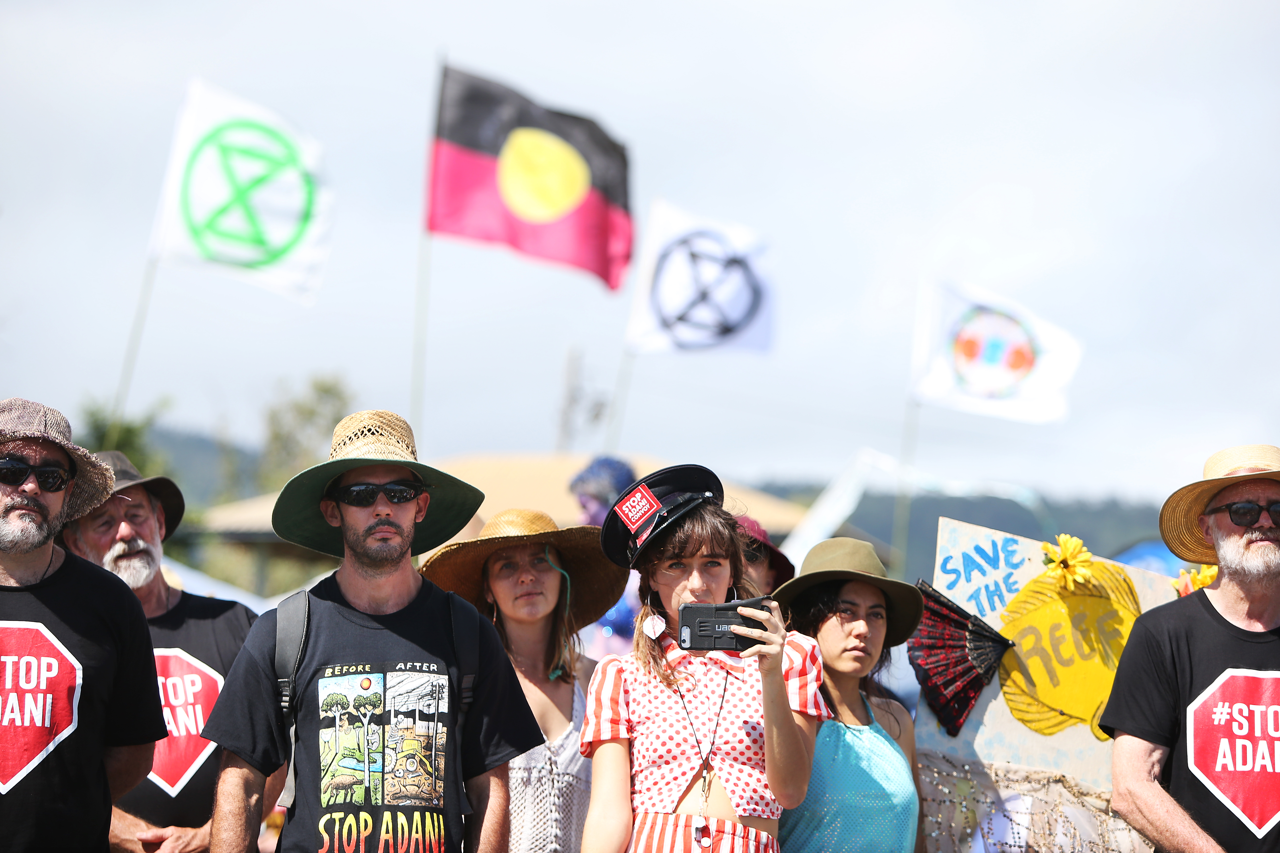 Environment activists and members of the public stand at the edge of Airlie Bay during an anti-Adani Carmichael coal mine rally on April 26th, 2019, in Airlie Beach, Australia.