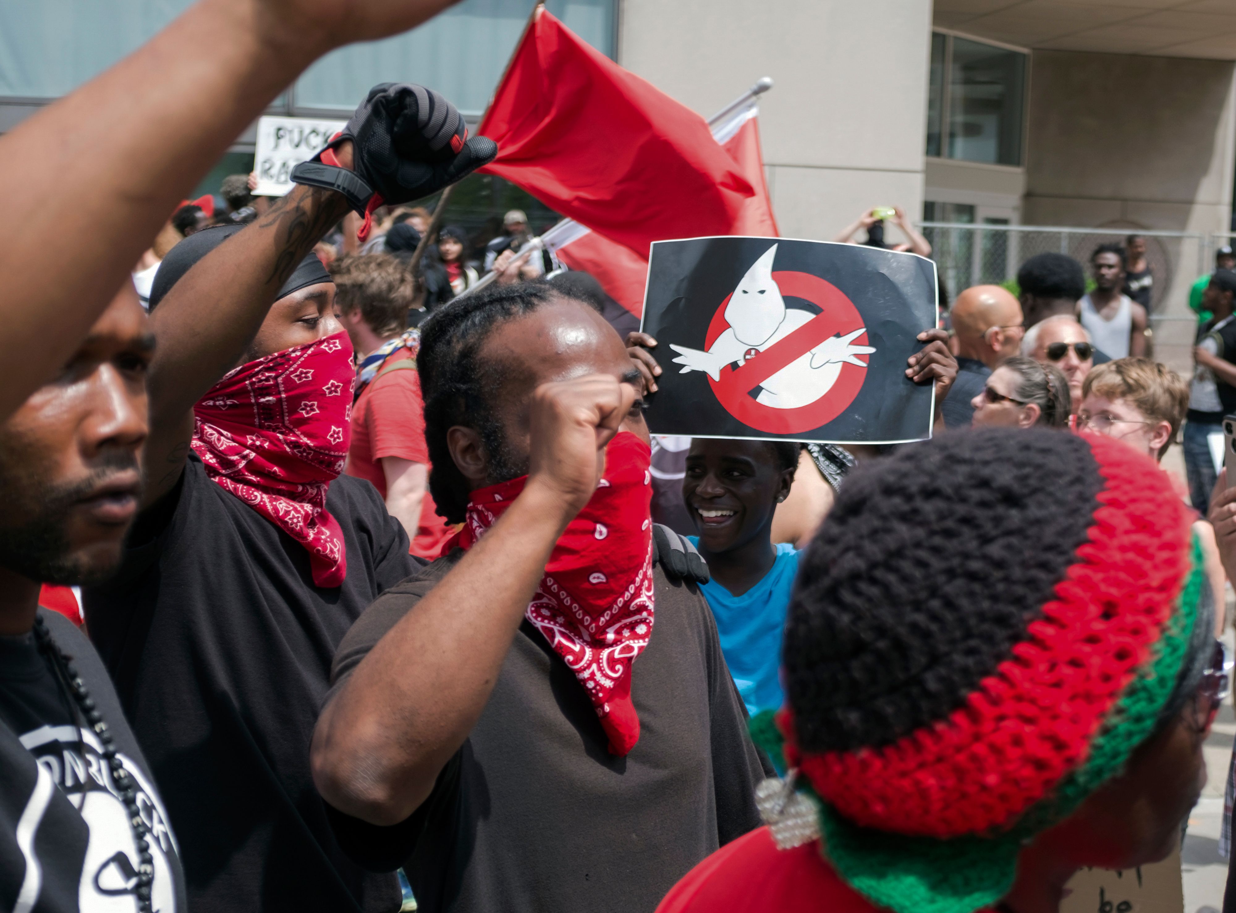 A young man holds a sign while protesting against the Honorable Sacred Knights on May 25th, 2019.