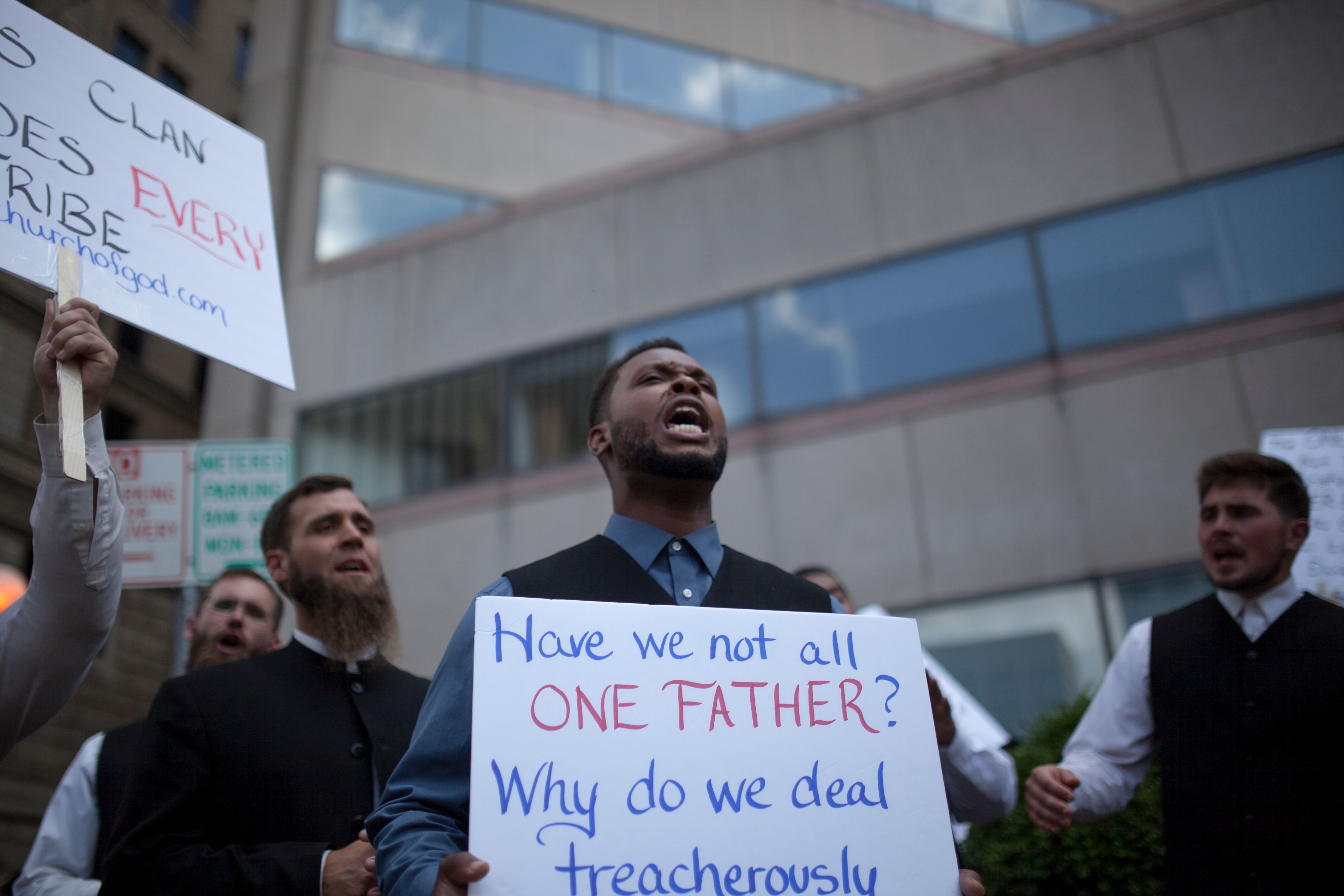 A religious counter-protester group sings church hymns during a demonstration against the rally by a small group from the KKK-affiliated Honorable Sacred Knights in Dayton, Ohio, on May 25th, 2019.