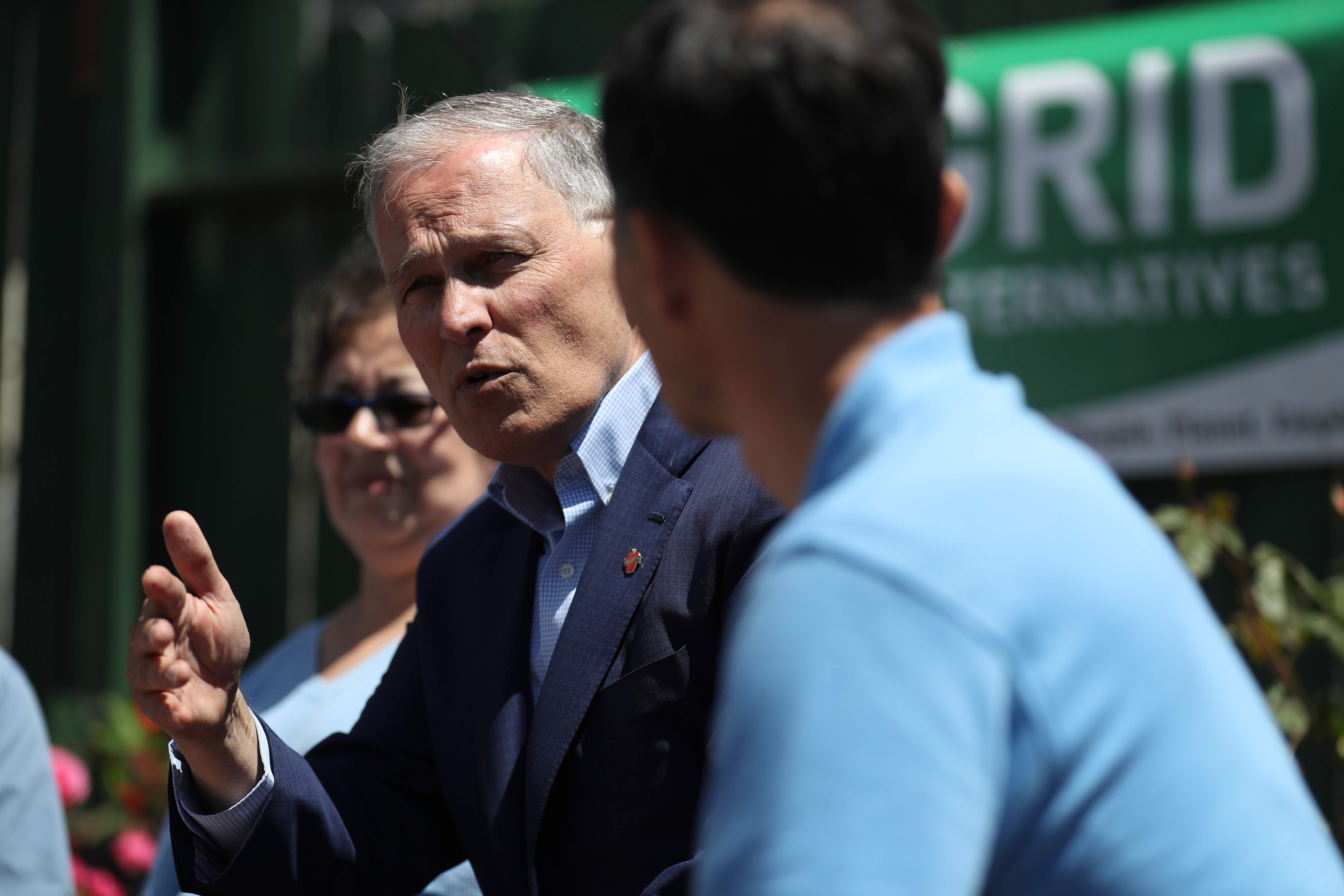 Democratic presidential candidate Washington Governor Jay Inslee talks with solar workers and homeowners about recent solar panel installations on their homes on May 2nd, 2019, in San Francisco, California.