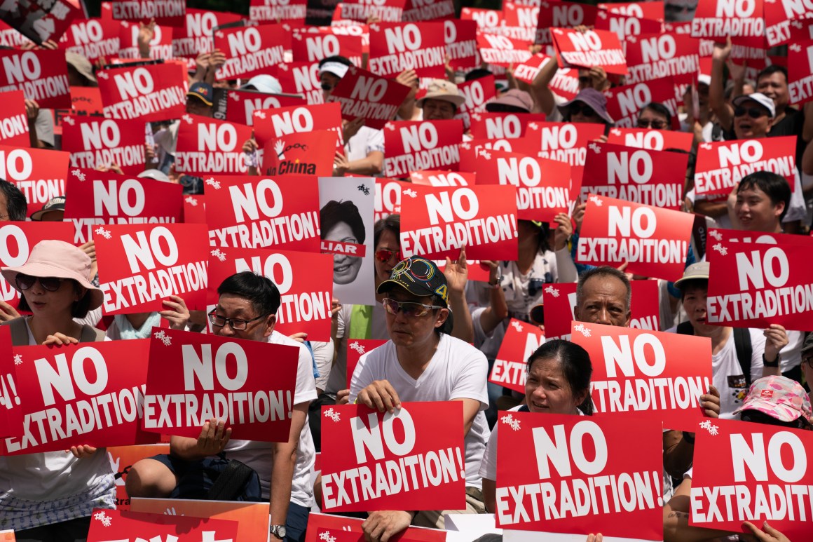 Protesters hold placards and shout slogans during a rally against the extradition law proposal on June 9, 2019, in Hong Kong.