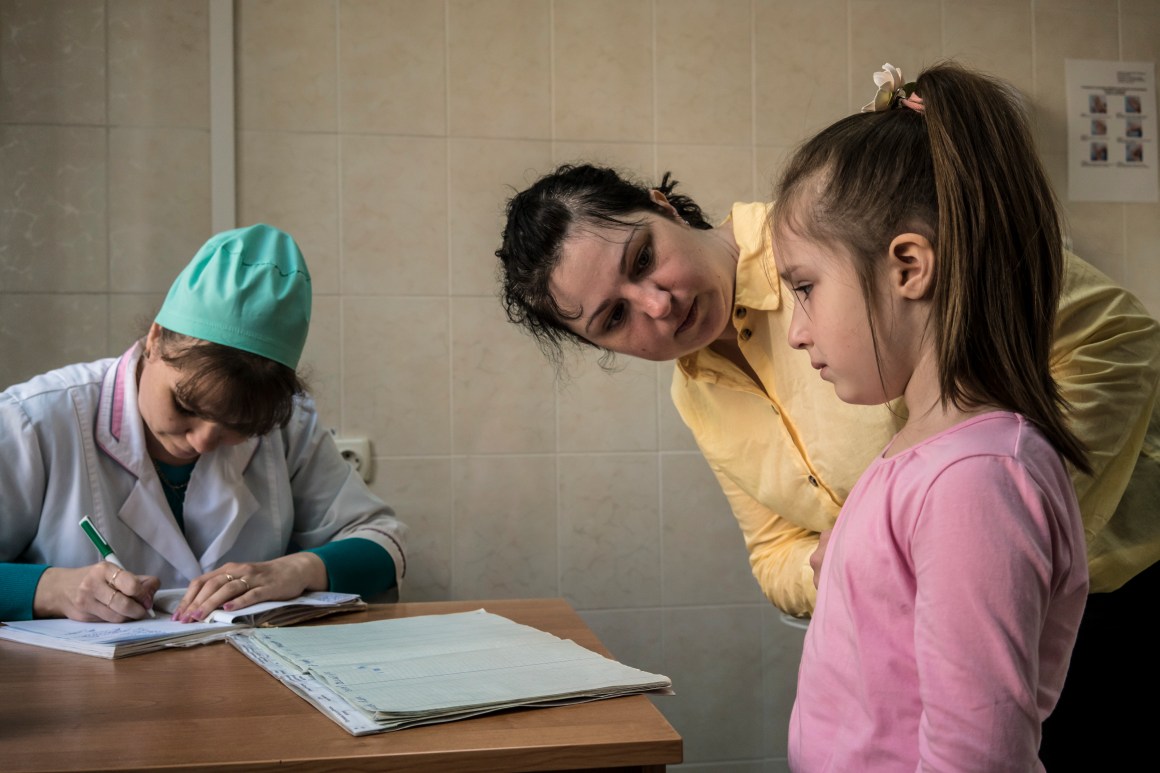 Katya Ganiyeva tends to her daughter Alisa Ganiyeva, age six, who is about to receive a measles vaccine shot from nurse Mariana Gonchara at a health clinic on May 15th, 2019, in Kiev, Ukraine. Ukraine is struggling with its largest measles outbreak in decades, with more than 34,000 confirmed cases so far this year, according to the World Health Organization.