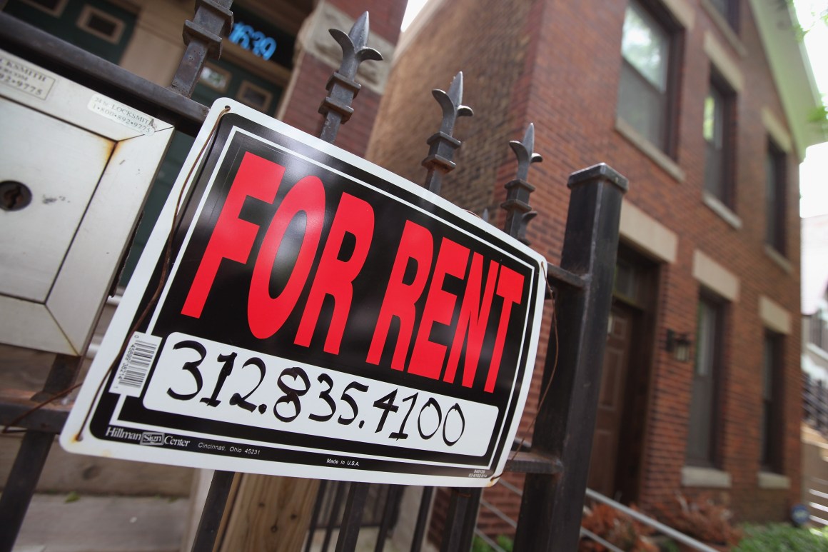 A For Rent sign stands in front of a house on in Chicago, Illinois.